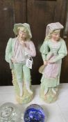 A pair of continental porcelain male and female figurines, 36 cm.