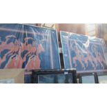 A pair of framed glazed pictures of erotic dancers.