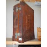 A good quality leather suitcase with initials E.J.R.