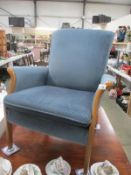 A blue fabric covered arm chair