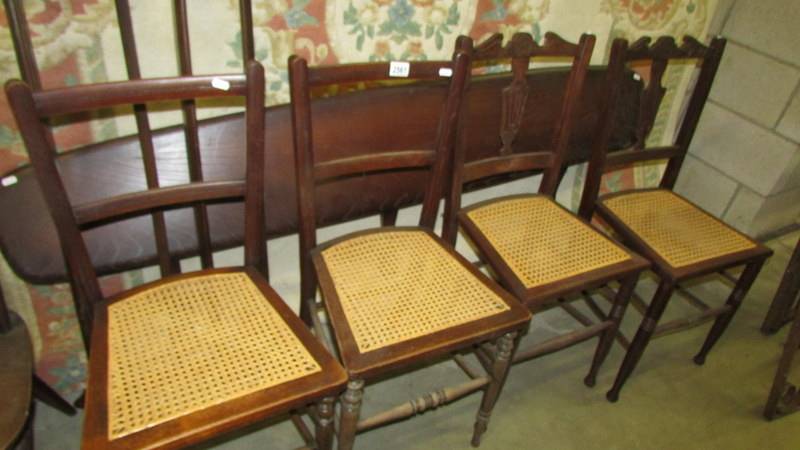 Two pairs of cane seated chairs.