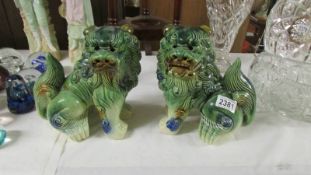 A pair of green pottery 'Dogs of Fo'.