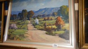 A mid 20th century oil on board country lane scene signed L R Evans.