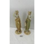 A pair of Royal Worcester candle sticks in the form of Grecian ladies,