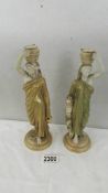 A pair of Royal Worcester candle sticks in the form of Grecian ladies,