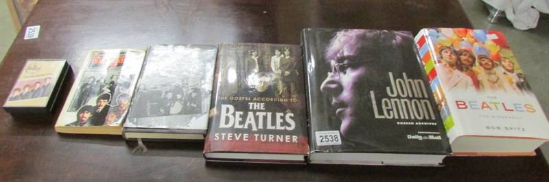 Five Beatles related books and a cassette tape.