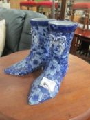 A pair of ornate blue and white china boots