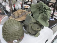 A US military helmet purportedly used in Vietnam and 2 hats and holdall