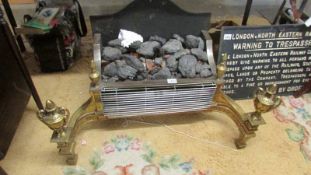 A heavy brass and metal coal effect electric fire.