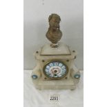 An alabaster mantel clock with enamel dial.