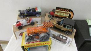 A collection of boxed tin plate cars and toys.
