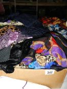 A large quantity of silk and other scarves.