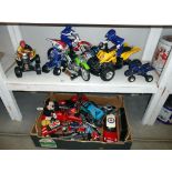 2 shelves of toys including motorcycles, quad bikes etc.