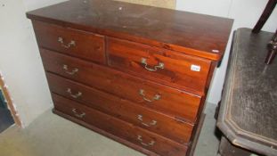 A stained pine 2 over 3 chest of drawers.