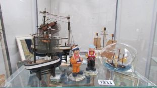 A model ship in bottle, 3 model fishing boats and life boat men figures,.