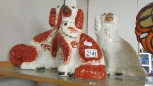A large Staffordshire spaniel and 2 smaller examples.