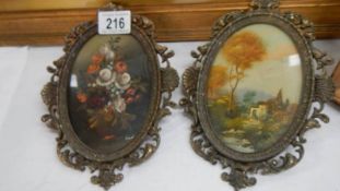 A pair of paintings in metal frames.