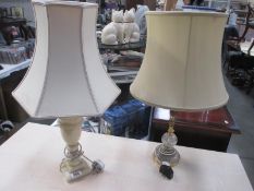 A brass and glass table lamp with shade and 1 other