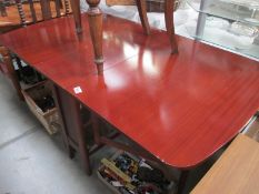 A darkwood stained drop leaf table 148cm x 83cm, 29cm x 83cm, height 72.