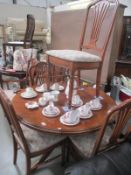 A round darkwood stained dining table and 6 chairs, diameter 108cm,