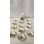 A Royal Crown Derby hunting scene tankard and 12 matching pin dishes.