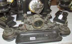 A superb quality desk stand with clock surmounted by figures,