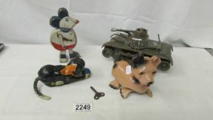 A tin plate tank, a tin plate clockwork cat (iwo), a clockwork dog (iwo) and wooden Mickey Mouse.