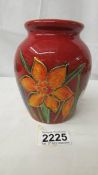 An Anita Harris Studio Pottery vase in daffodil design, 13 cm tall, signed in gold to base.