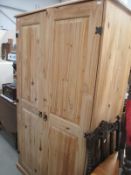 A solid pine 2 door wardrobe, unpolished (doors may need re-hanging) 100cm x 56cm,