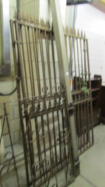 A pair of tall drive gates and a garden gate.
