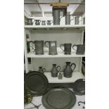 A good collection of period pewter including measures, tankards, plates etc.