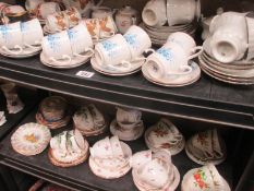 A quantity of teaware on 2 shelves