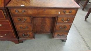 A mahogany kneehole desk.