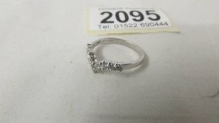 An 18ct ct gold wishbone style half carat diamond ring, size N.
