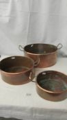 A graduated set of 3 copper pans.