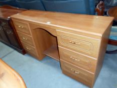 A modern teak effect double pedestal dressing table 138cm x 41cm x height 79cm