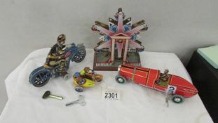 A collection of boxed and unboxed tin plate and other toys.