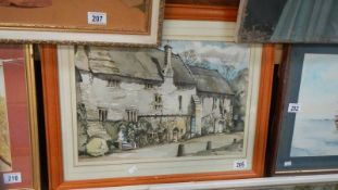 A framed and glazed watercolour village scene.