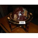 A gem stone globe in brass stand with compass in base Height 22cm,