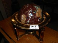 A gem stone globe in brass stand with compass in base Height 22cm,