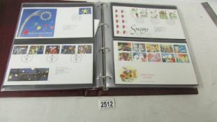 An album of assorted first day covers.
