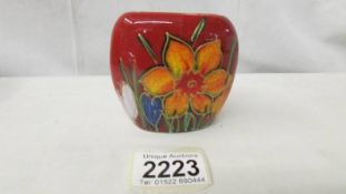 An Anita Harris Studio Pottery purse vase in daffodil design, 7 cm tall, signed in gold to base.