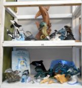 2 shelves of sea animal ornaments, mainly dolphins, in pottery, wood, resin etc.