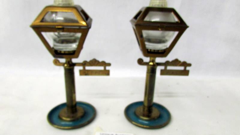 A pair of unusual ornate salt and pepper pots in the form of street lamps.