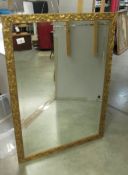 A gilt framed bevel edged mirror, 100 x 69 cm.