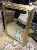 A gilt framed bevel edged mirror.