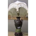 A bronze table lamp with shade.