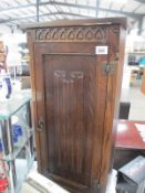 An 'Old Mill' oak cupboard with linen drape door CD storage cupboard Height 85cm, 40.5cm x 20cm.