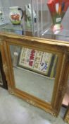 A gilt framed bevel edged mirror, 82 x 71 cm.