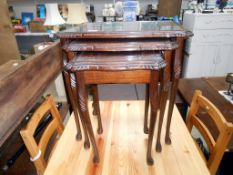 A dark wood stained nest of tables with glass tops 55cm x 41cm x height 56cm